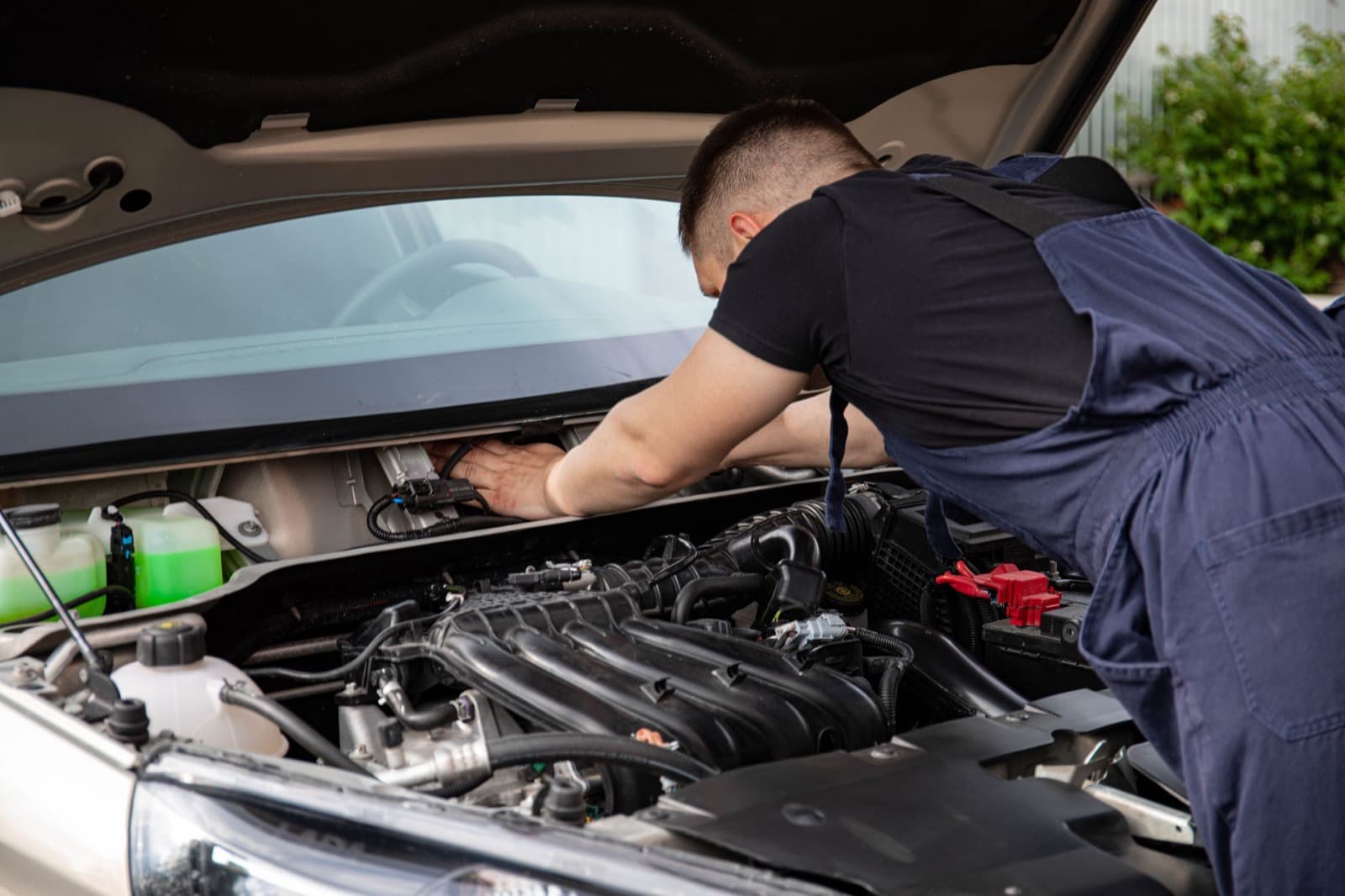 Mechanic working under a bonnet